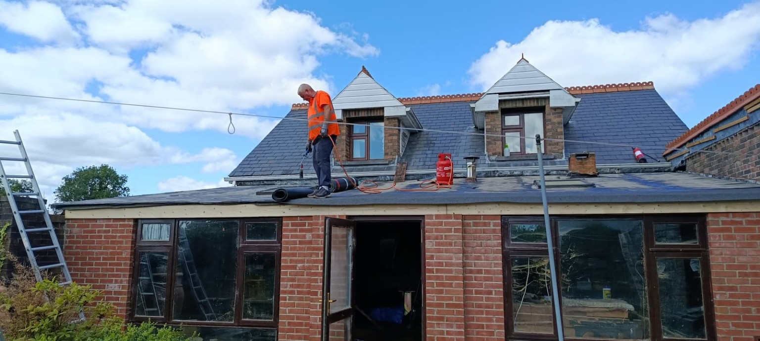 Mr Flat Roof installing felt on a residential flat roof